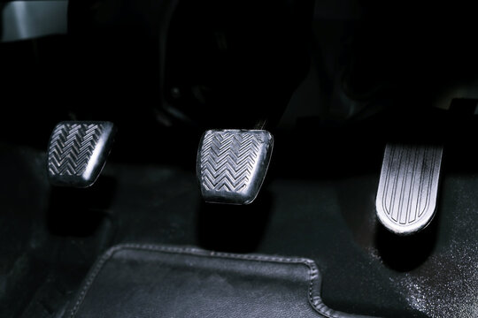 Closeup pedal of car brake. To slow down, stop the car both normal and abruptly, transfer the weight to press the front wheels to grip the road and turn more stable.	