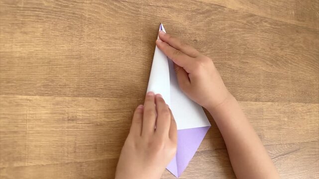 Child Hands Folding Lavender Origami Paper Step Four, 4K