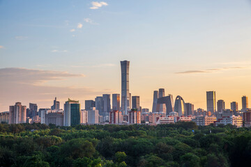 Beijing CBD city skyline with green trees and sunset scenery, China © 肖勇