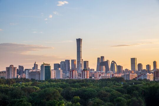 Beijing CBD city skyline with green trees and sunset scenery, China