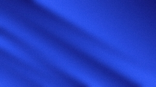 Aerial view of a blue fabric with folds and creases on a plain surface