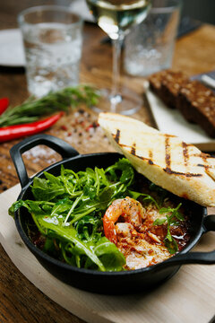 Rustic seafood starter with grilled bread and fresh herbs