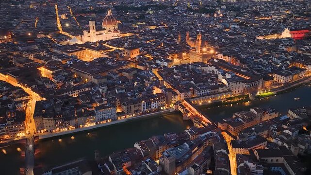 Florence, Italy. Aerial night 4K panoramic drone view of the city at dusk. Majestic view of the ancient city skyline with Basilics, Palazzo Vecchio, bridges, iconic buildings. Europe from above.
