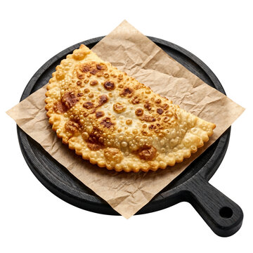 Golden Fried Cheburek on Black Wooden Platter with Brown Paper - Isolated