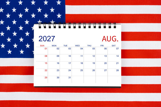 August 2027 desk calendar on United States of America flag.