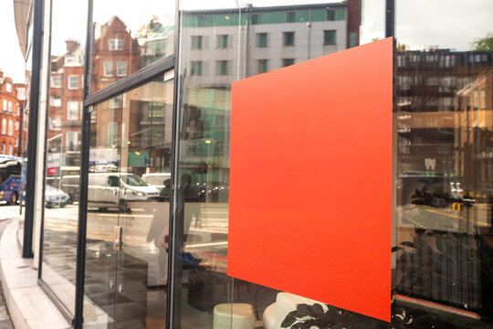 LONDON - blank orange advertising panel on shop window