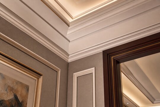 Decorative molding where ceiling and wall meet in an elegant joint.