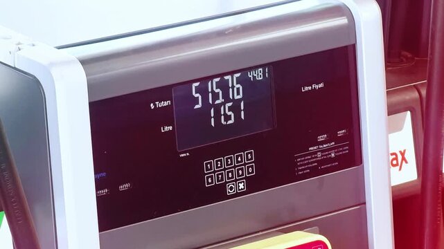 Gas station fuel meter counter price. Close up while refueling a car. Close-up of petrol station with running numbers on gas pump.
