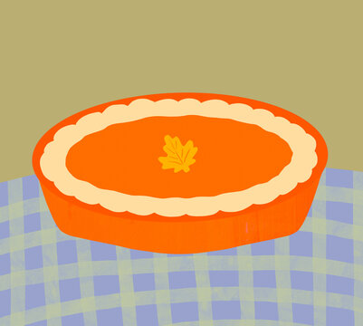 Cozy homemade pumpkin pie in bright orange pie dish with autumn leaf