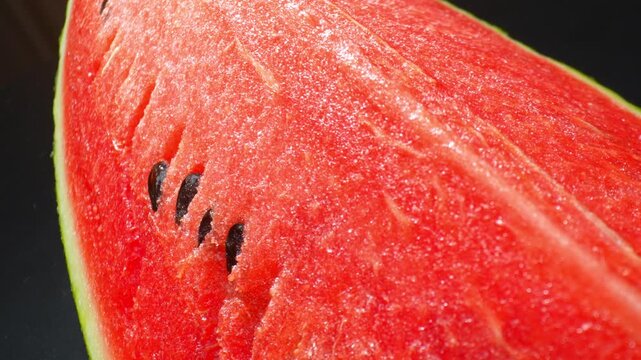 Close-range capture of watermelon pulp featuring vivid color and moist texture, emphasizing fruit freshness, nutritional value, and the appeal of naturally hydrating foods. 4k.
