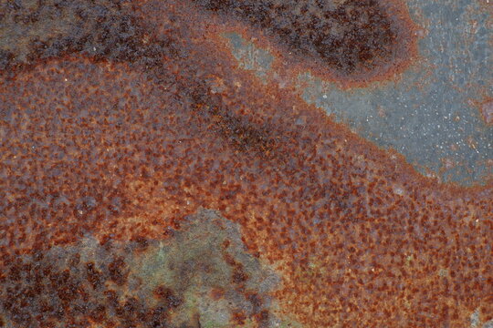 The surface texture of old iron plate, corroded and naturally rusted, with an abstract brownish pattern. Perfect for industrial and grunge-themed design backdrops.