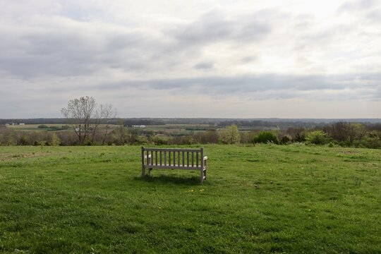 The empty wood bench in the country field.