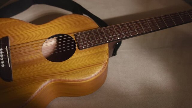 Acoustic guitar resting on soft fabric in warm light