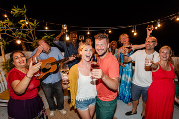 Obraz premium Diverse group of men and women enjoying a lively outdoor party