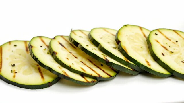 Grilled zucchini slices on white plate