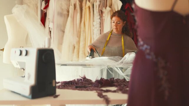 Professional seamstress ironing wedding dress tulle
