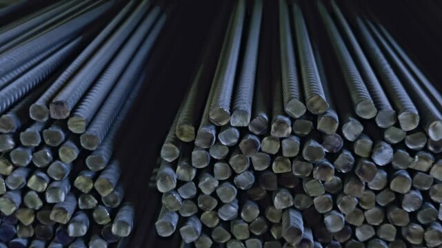 Rows of metal rebar stand ready for construction, industrial material for building projects.