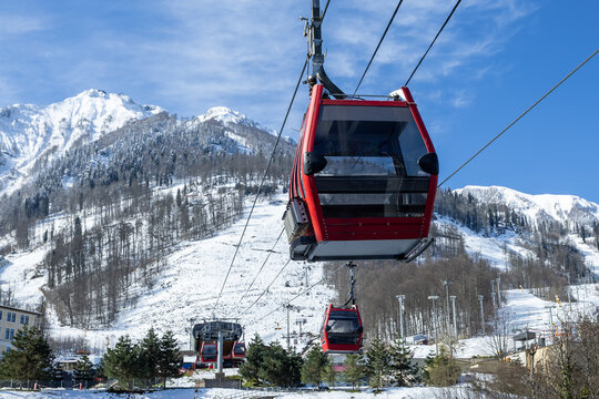 Aerial lift at a ski resort against the backdrop of snow-capped mountains