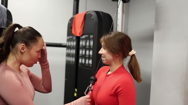 A gym trainee starts inventing her own version of an exercise on an unfamiliar machine the moment her trainer looks away creating a funny fitness misunderstanding