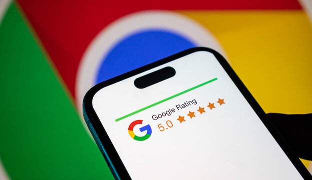 Closeup of a smartphone screen displaying a 50 google rating with the google chrome logo in the background