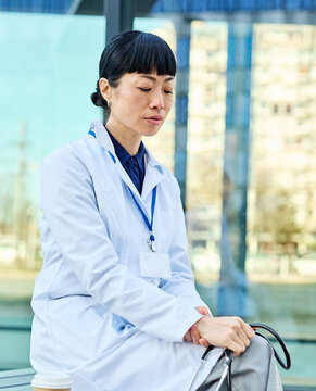 Portrait of a female woman doctor or nurse and  health care worker in front of hospital or clinic outside