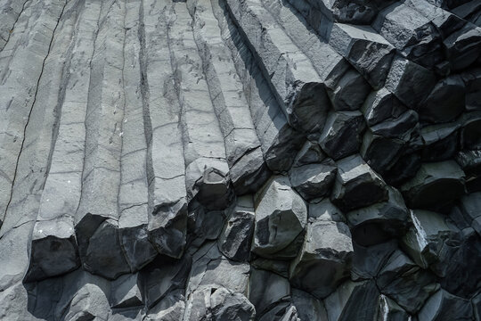 Columnar basalt rock formations with hexagonal pillars and rugged texture,ICELAND