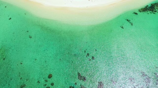 Seascape with tropical sandy beach and blue ocean. Pagudpud, Ilocos Norte, Philippines.