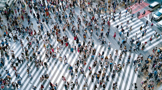 Overhead crowd crossing multiple zebra crosswalks in city intersection