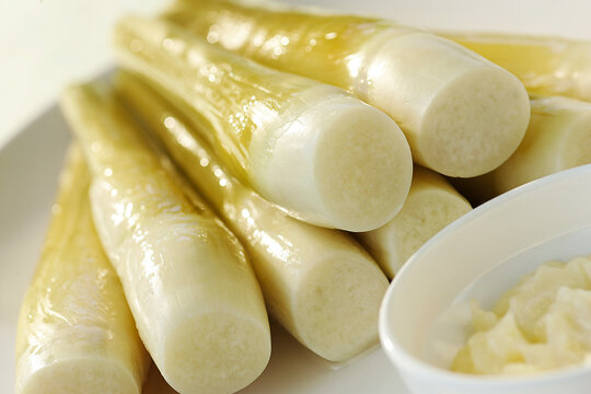 Cooked palm hearts with mayonnaise on a white plate