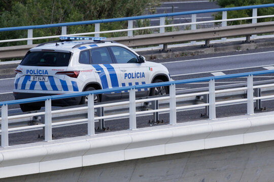 Portuguese pol&iacute;cia de seguran&ccedil;a p&uacute;blica car driving on highway bridge