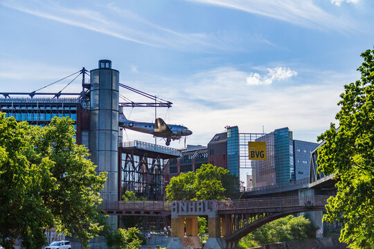 Berlin, Germany - June 2 2019: Vintage military aircraft suspended above a railway bridge in Berlin with BVG sign