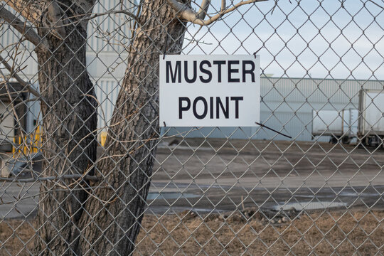Muster point sign attached to Chain Link Fence