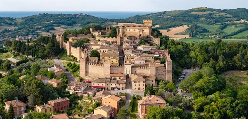 Gradara medieval borgo drone panoramic view in Marche with sea background. Most beautiful medieval villages of Italy. aerial view of ancient fortified castle town surrounded by rolling green hills  © Freesurf