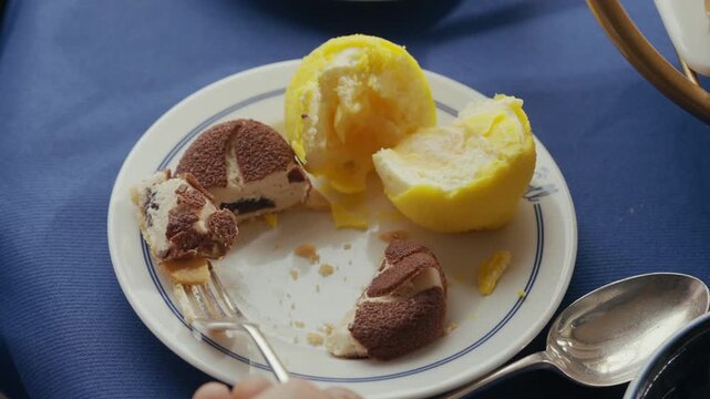 Plate of tiramisu and lemon sorbet sits on a blue tablecloth