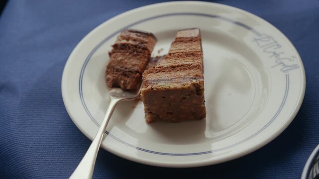 Chocolate cake slices on a plate with silver fork for afternoon tea
