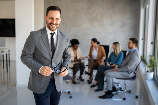 Successful executive standing proudly in office, representing business growth, partnership