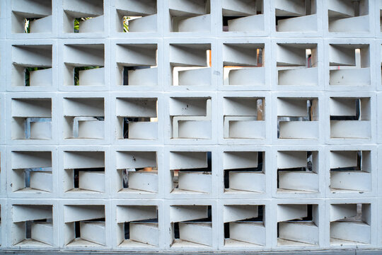 White concrete ventilation breeze blocks wall pattern background under bright daylight with modern geometric architecture design