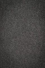 Fototapeta premium Black asphalt surface shows texture and detail in urban setting during daylight hours