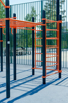 empty outdoor workout area with metal bars and parallel bars on rubber floor. this workout space is perfect for daily fitness and sport. public workout zone promotes active lifestyle in city.