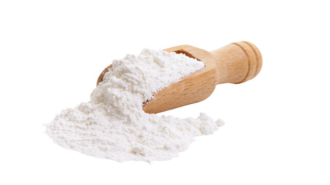Wooden scoop filled with white flour powder spilling onto surface