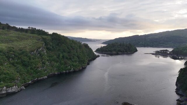 Aerial drone footage captures a push forward movement over the historic Castle Tioram. Set on the west coast of Scotland, UK on a the spring afternoon.