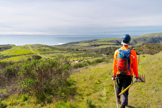 trail construction worker surveying land 