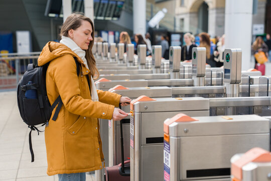Woman Using Ticket Machine at Train Station 