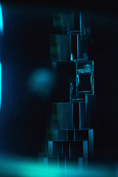 Abstract figures holding a perfume bottle glow with blue light