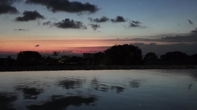 sunset at a rooftop pool in kuta on bali