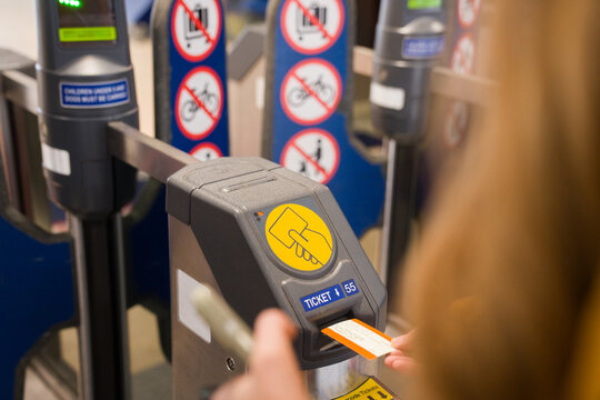 Person Using Ticket Machine at Transit Station 