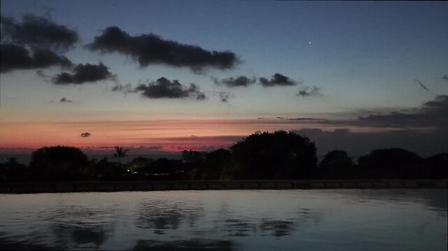 sunset at a rooftop pool in kuta on bali