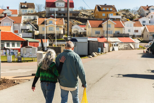 Back View of Senior Couple Walking in Swedish Village