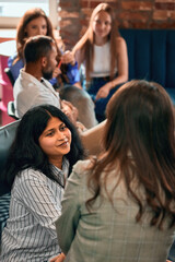 Colleagues talking during informal office discussion session. Concept of leadership coaching, HR training, employee onboarding, workplace collaboration, soft skills, and business mentoring.