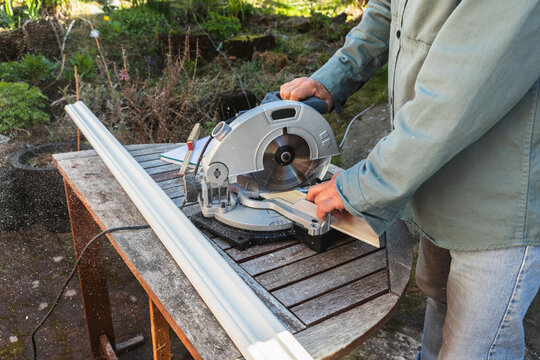 Sawdust Flying from Power Saw Cutting Wood